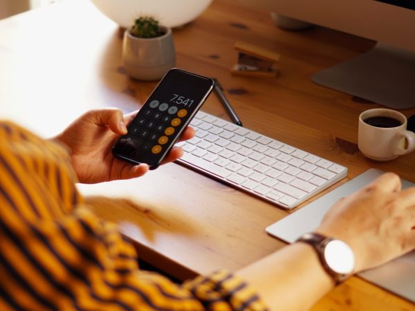 A closeup shot of an entrepreneur working from home and doing calculations